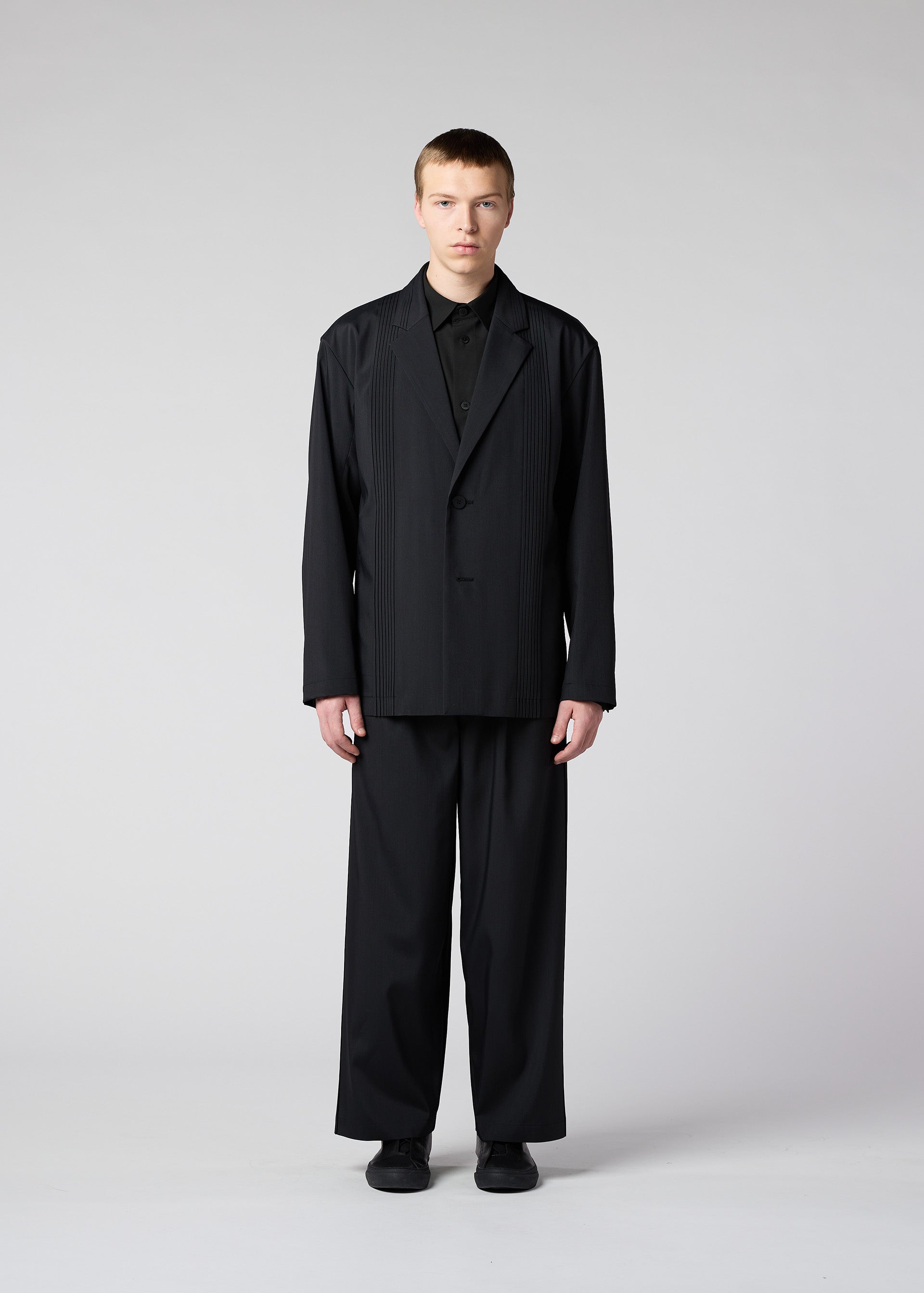 A model wears the IM Men AIR PLEATS jacket.