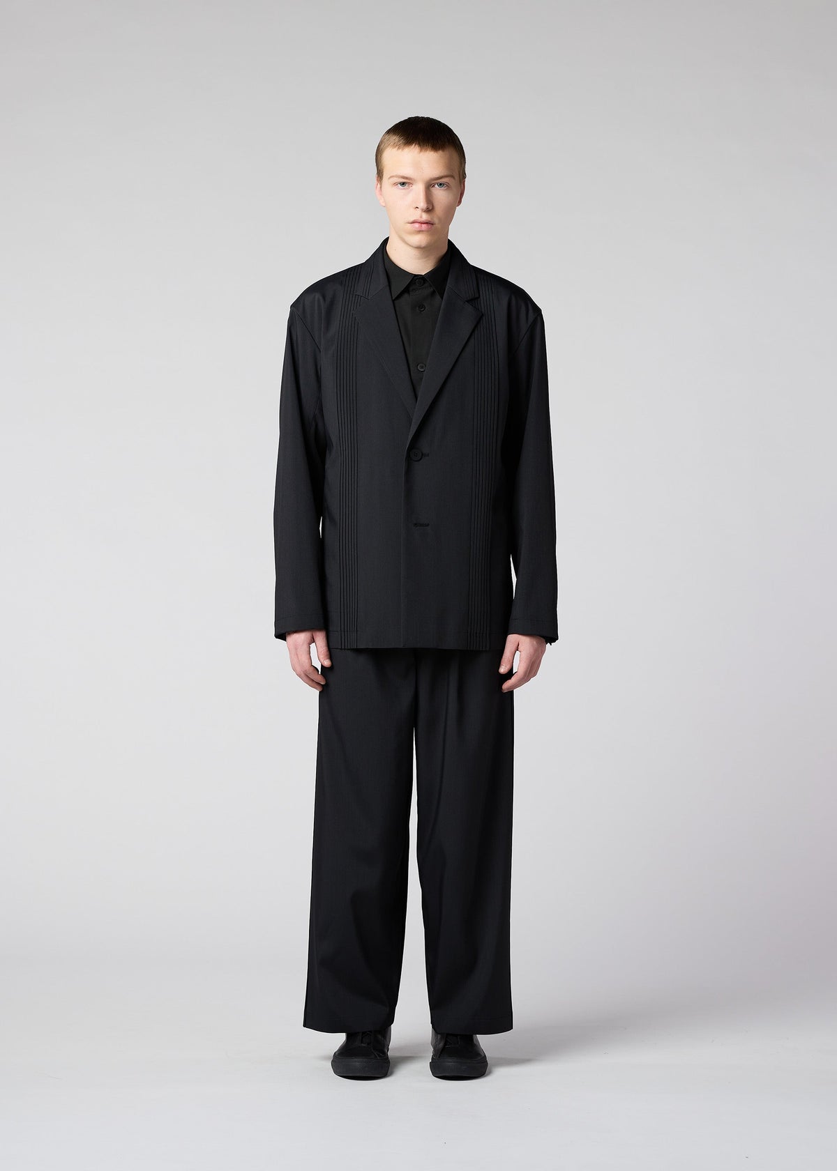 A model wears the IM Men AIR PLEATS jacket.