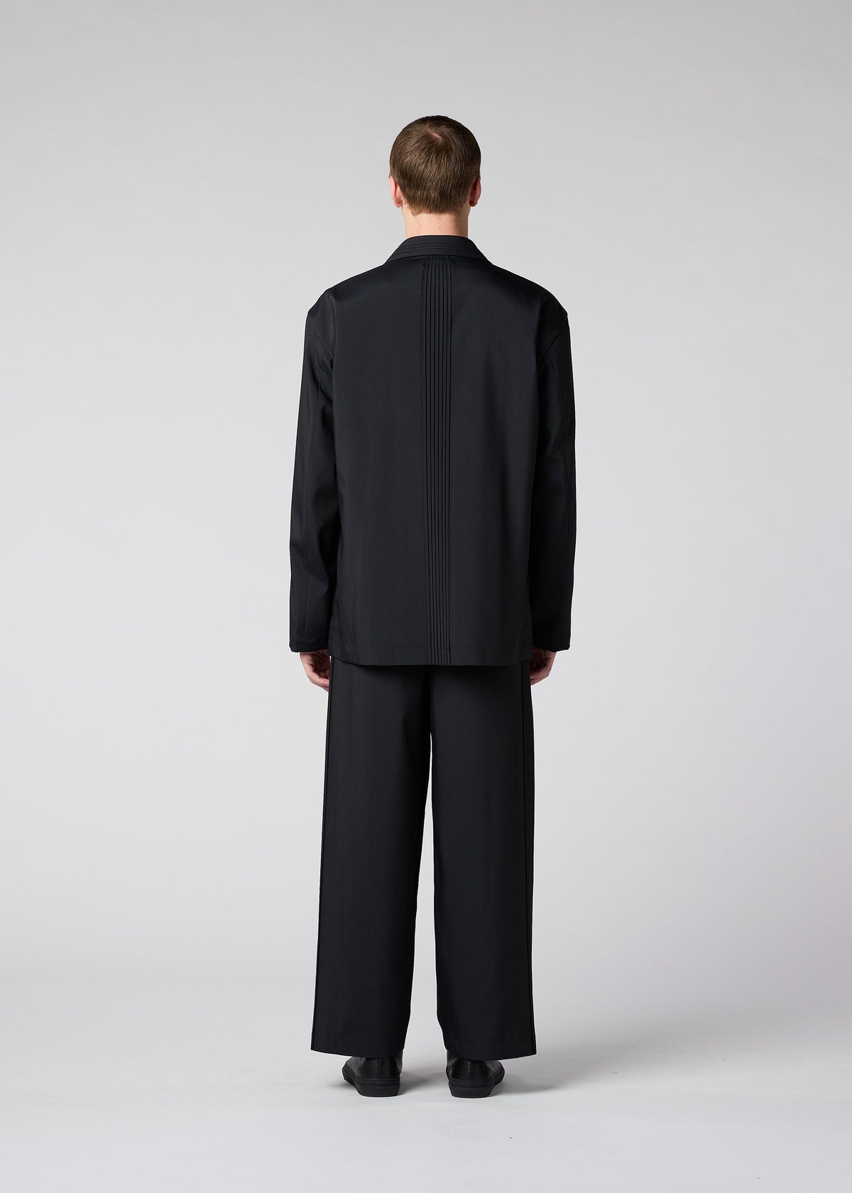 A model wears the IM Men AIR PLEATS jacket.