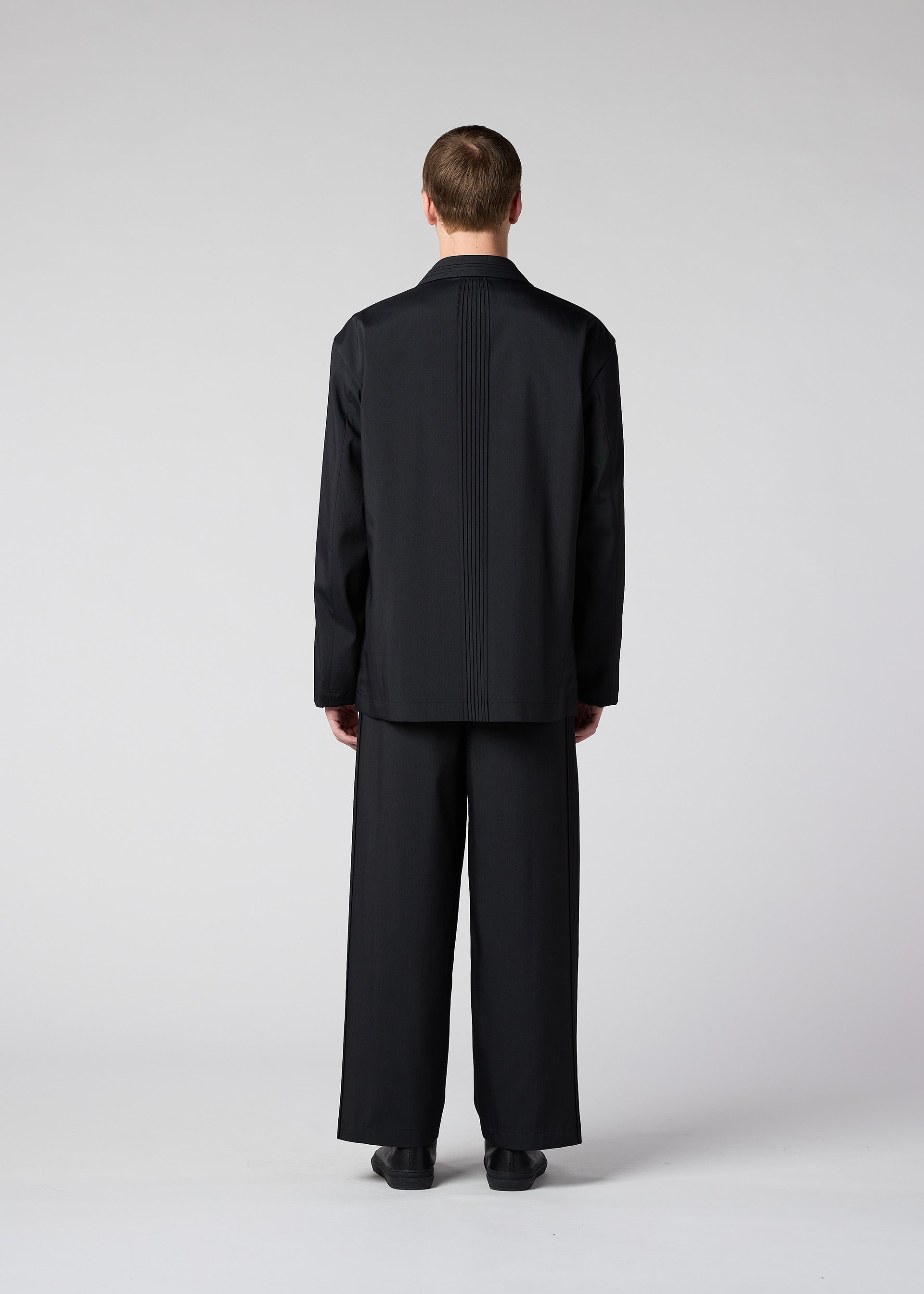 A model wears the IM Men AIR PLEATS jacket.