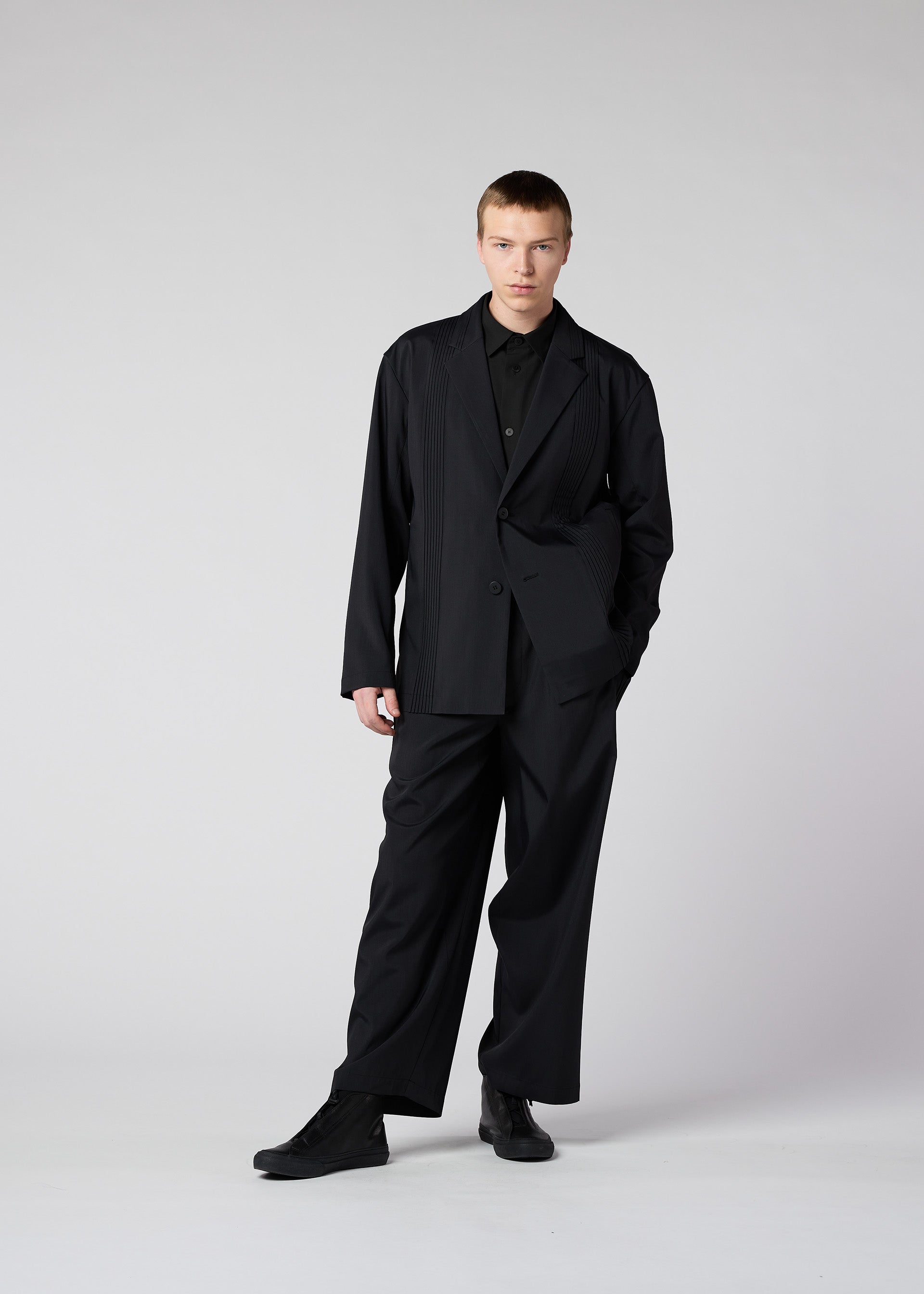 A model wears the IM Men AIR PLEATS jacket.