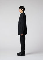 A model wears the IM MEN SHRINK DYE trousers.