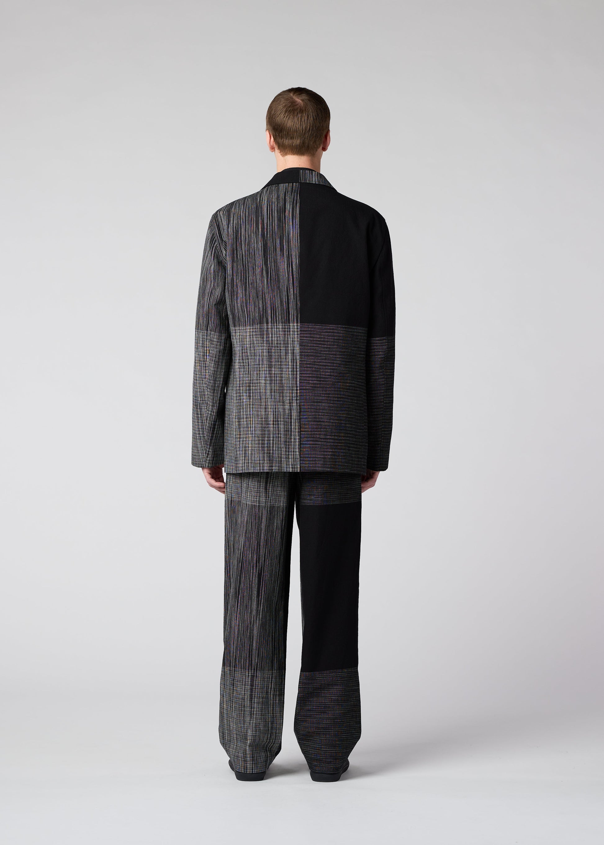 A model wears the IM MEN KASURI trousers.
