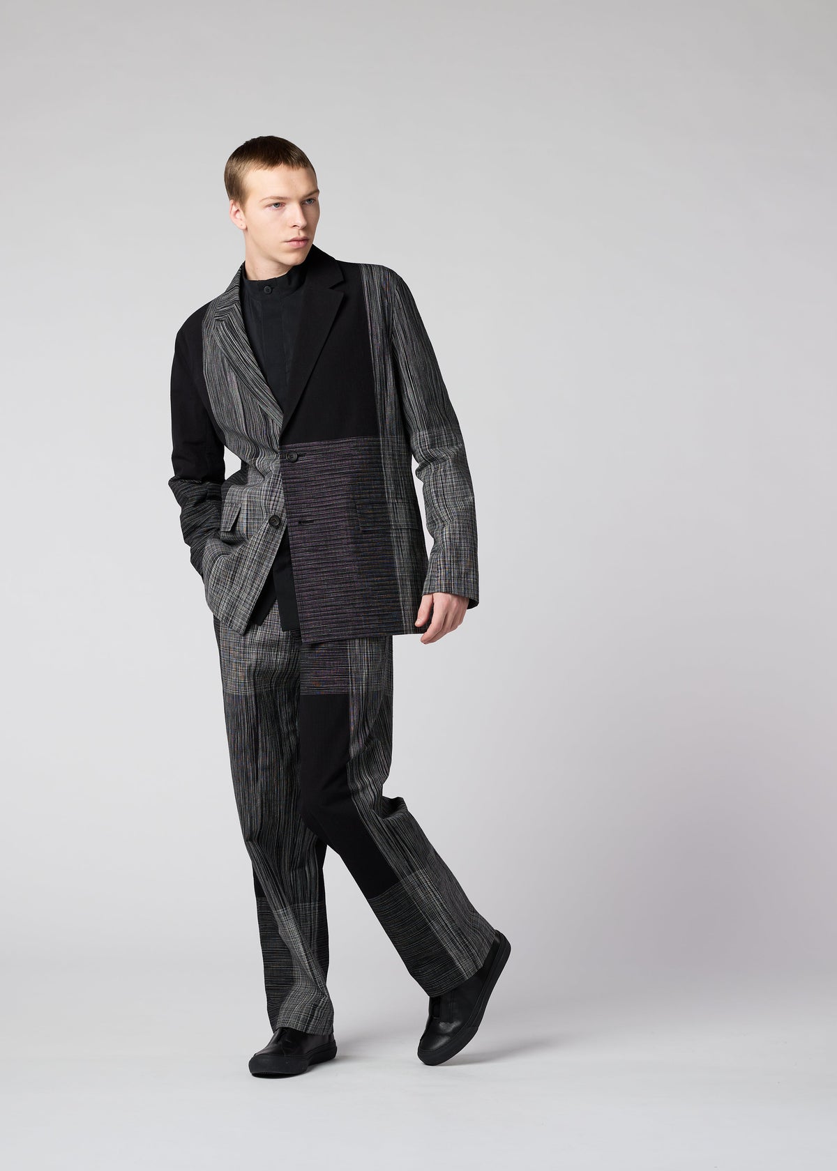 A model wears the IM MEN KASURI trousers.