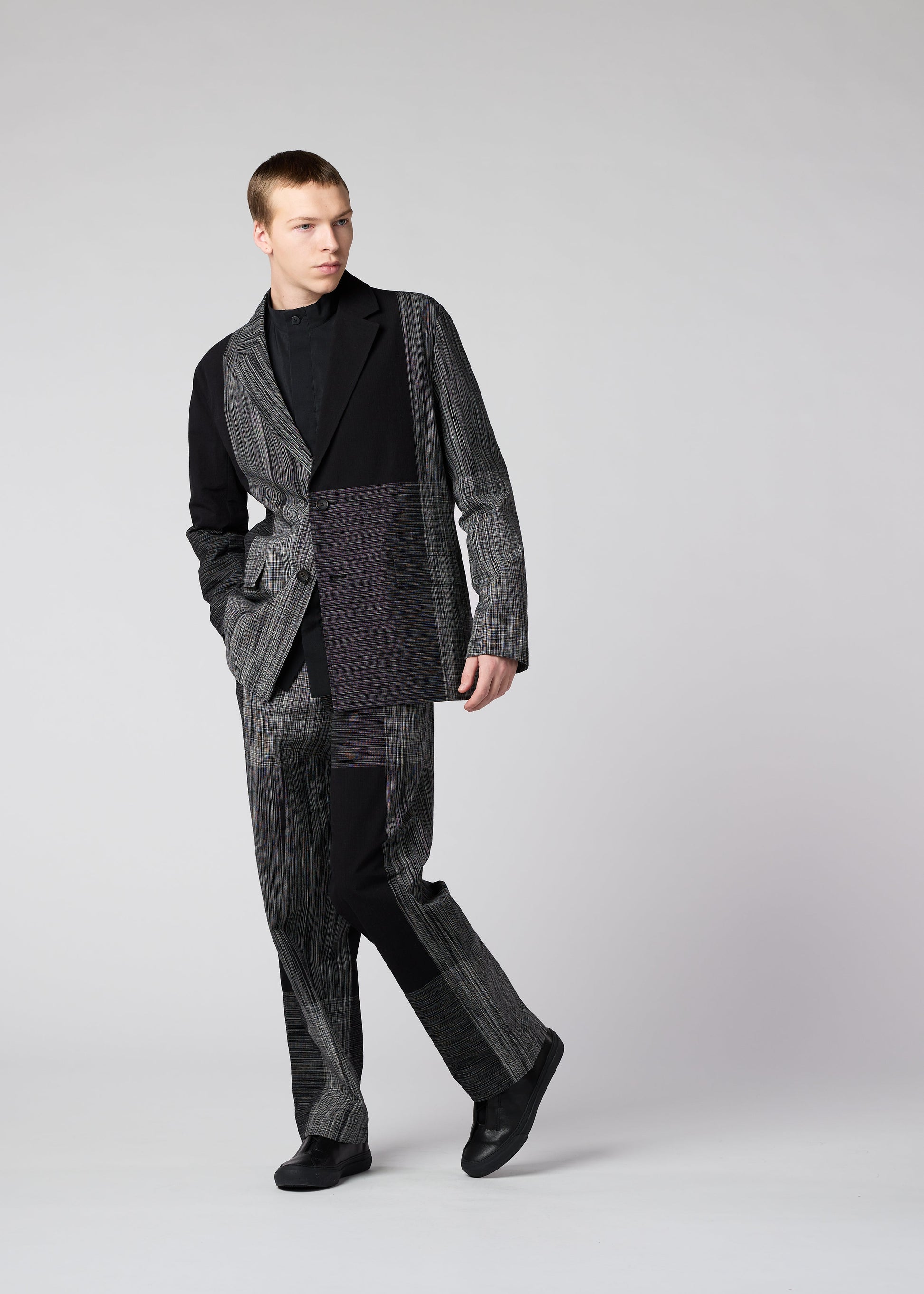 A model wears the IM MEN KASURI trousers.
