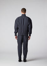 A model wears the IM MEN WAFT trousers.