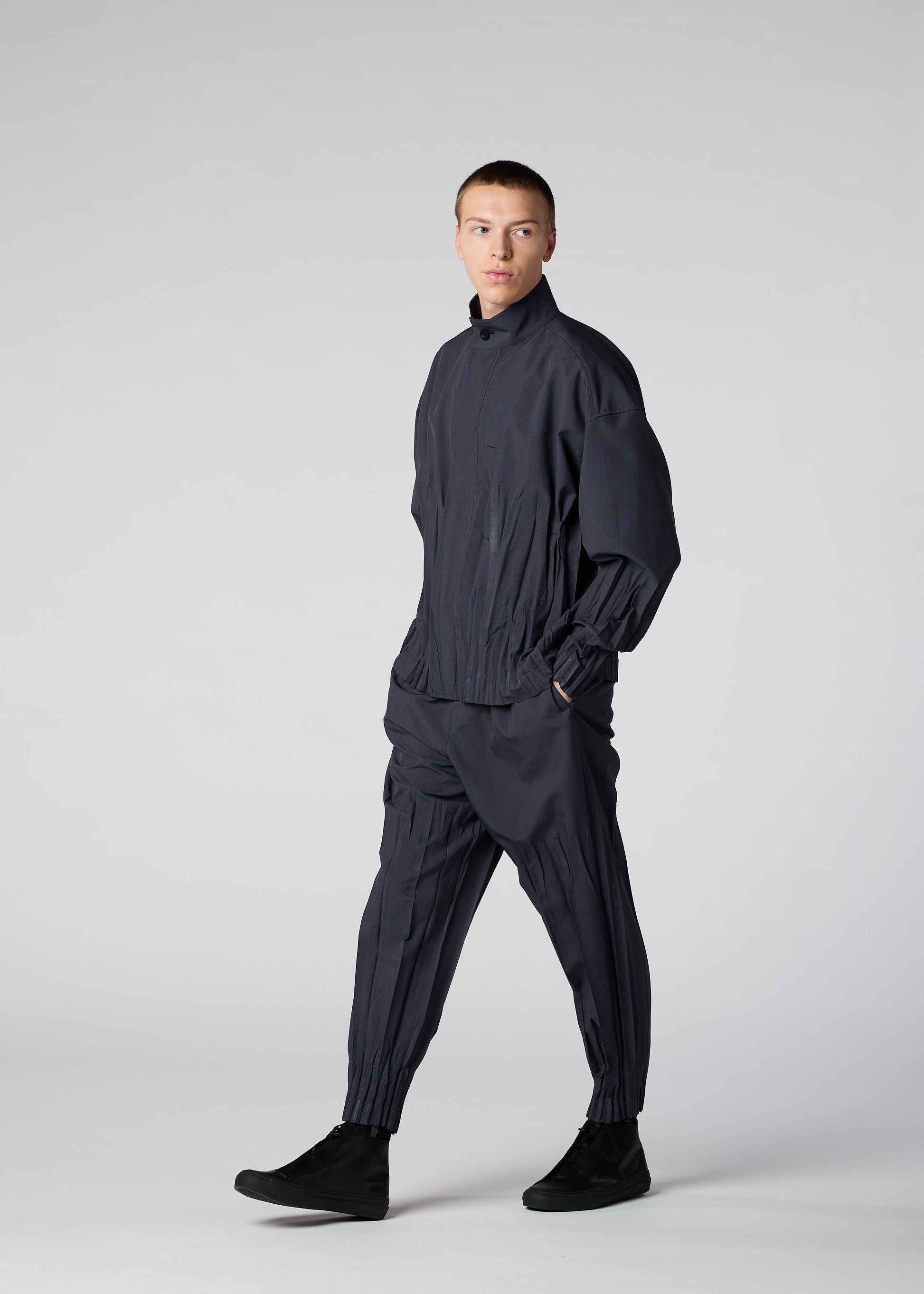 A model wears the IM MEN WAFT trousers.