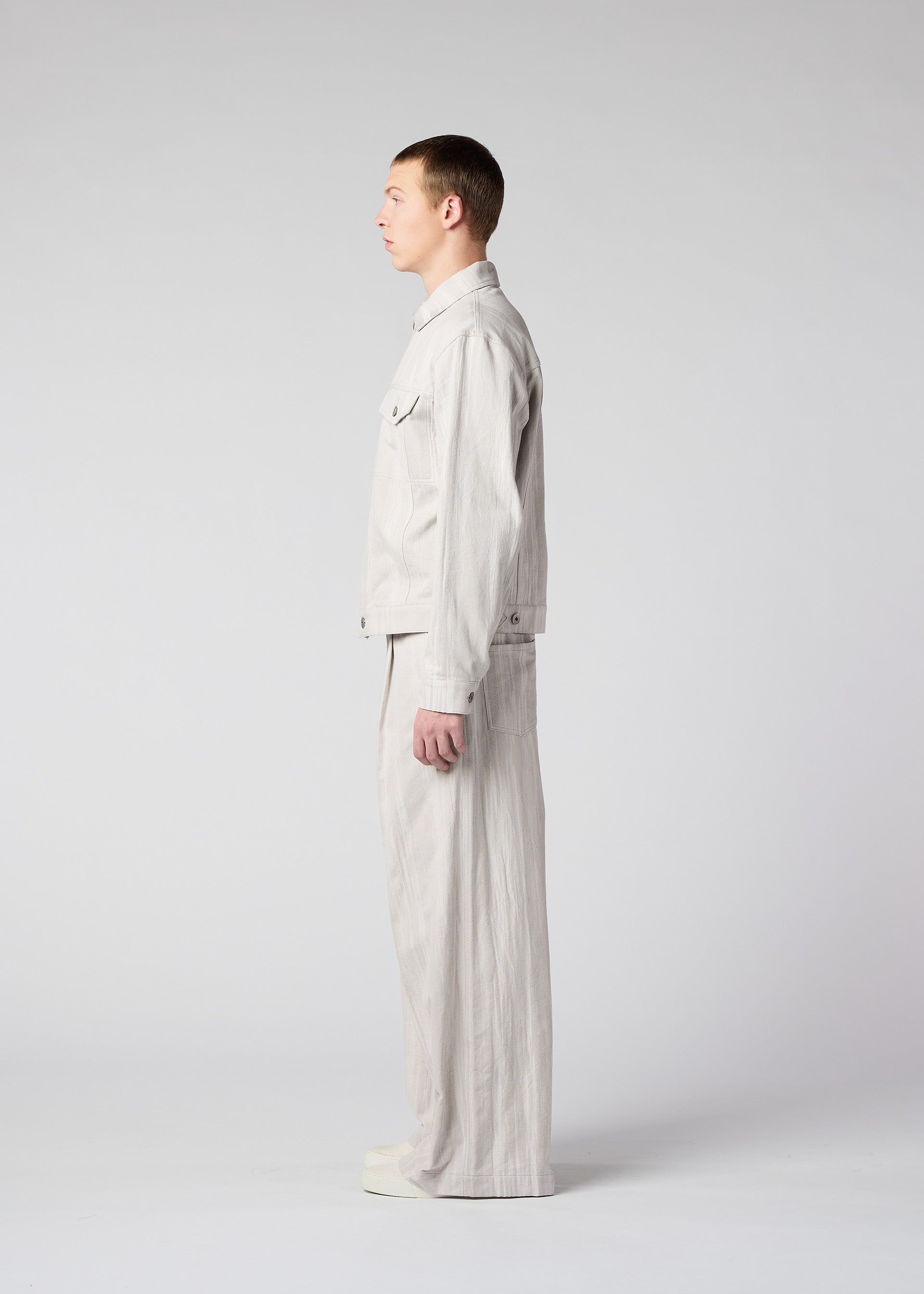 A model wears the IM Men COTTON JACQUARD trousers.