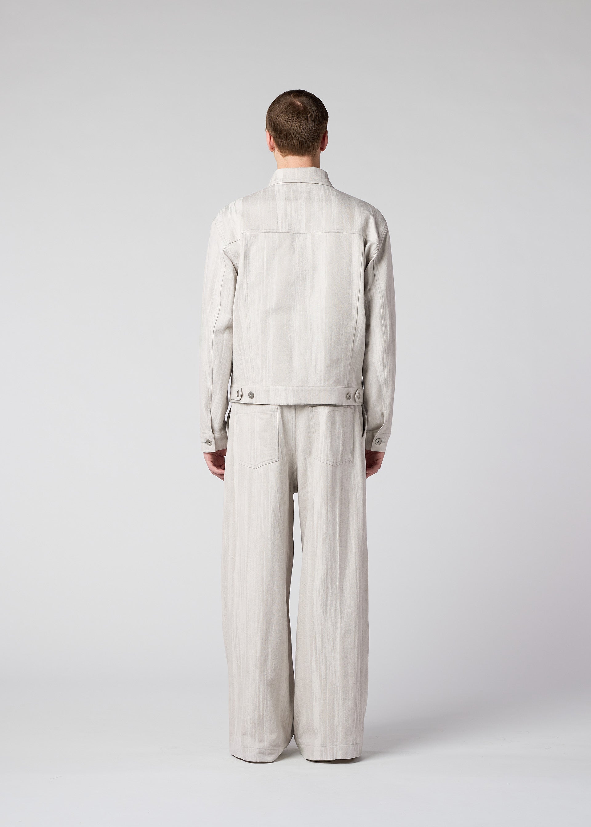 A model wears the IM Men COTTON JACQUARD trousers.