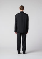 A model wears the IM Men AIR PLEATS trousers.