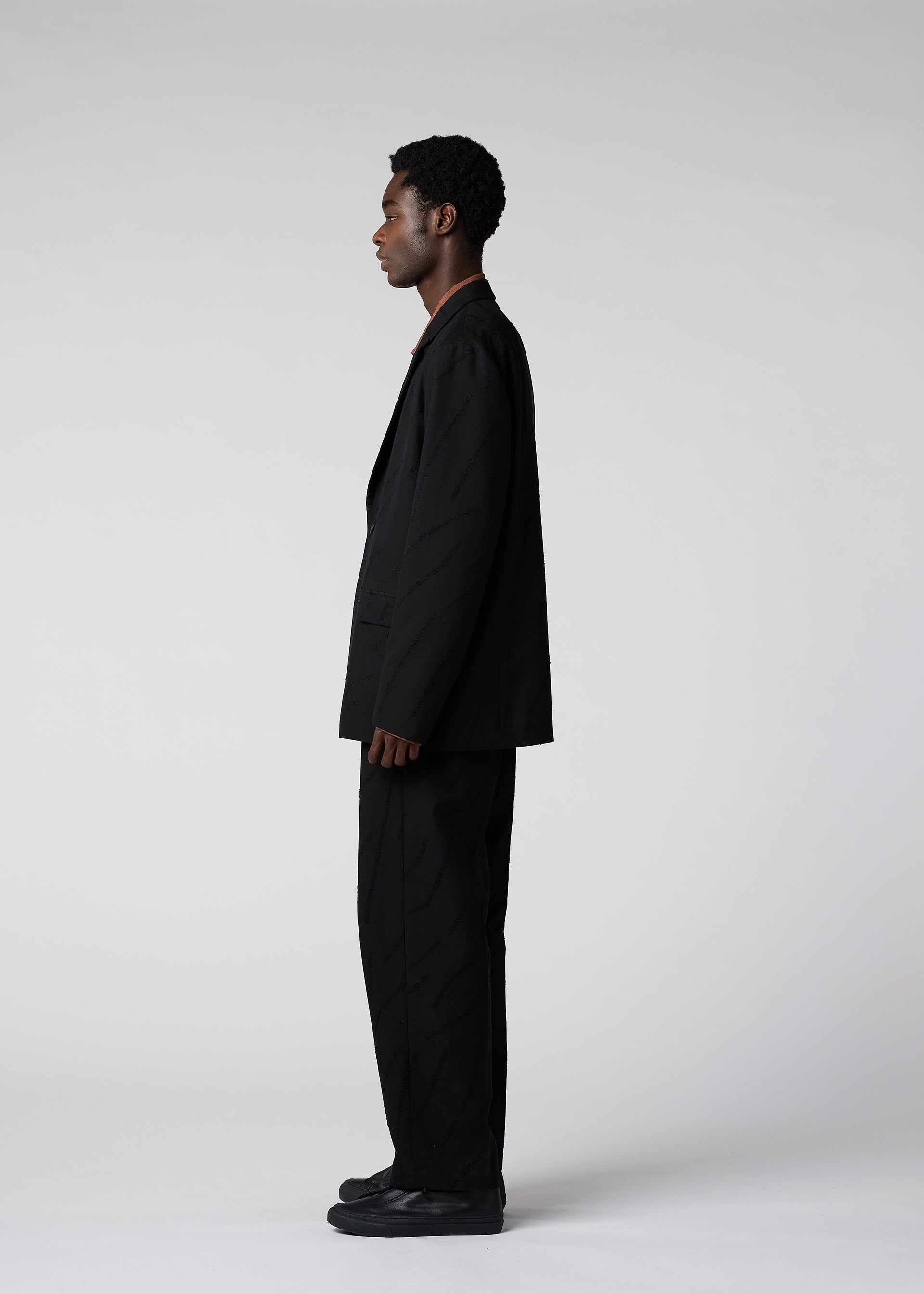 A model wears the IM MEN FLY WOOL trousers.