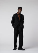 A model wears the IM MEN FLY WOOL trousers.