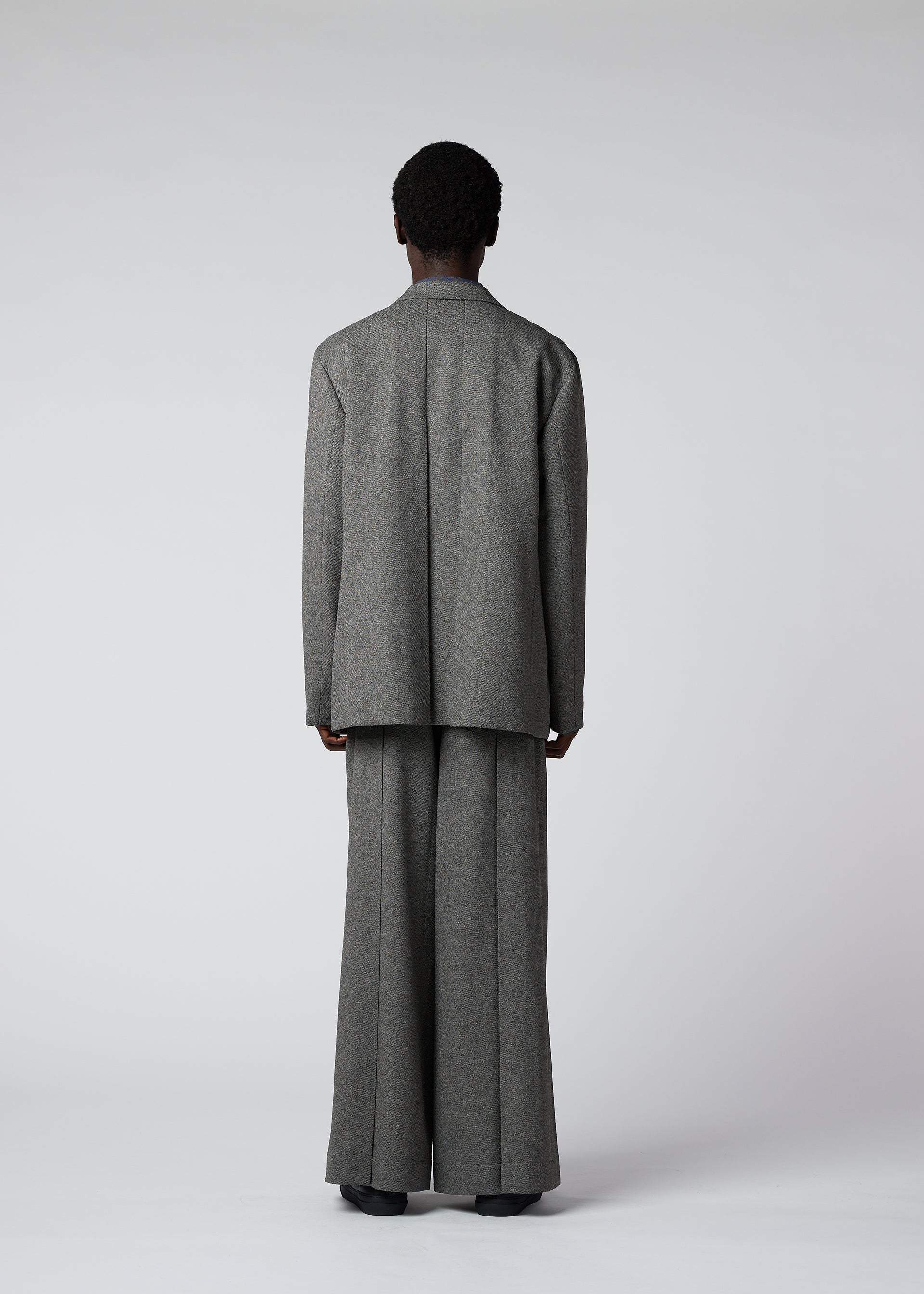 A model wears the IM Men WOOL LIKE TWEED trousers.