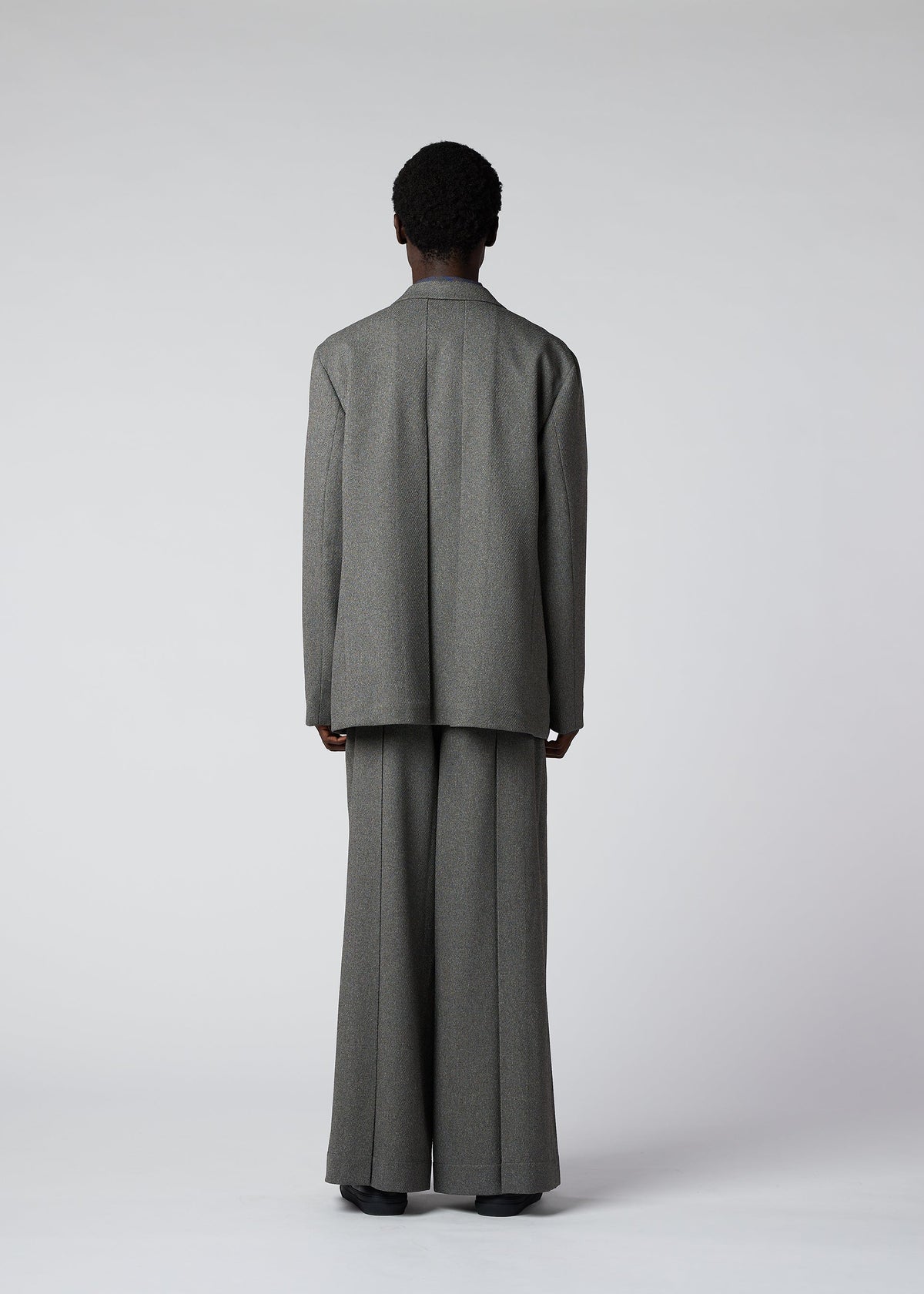 A model wears the IM Men WOOL LIKE TWEED trousers.