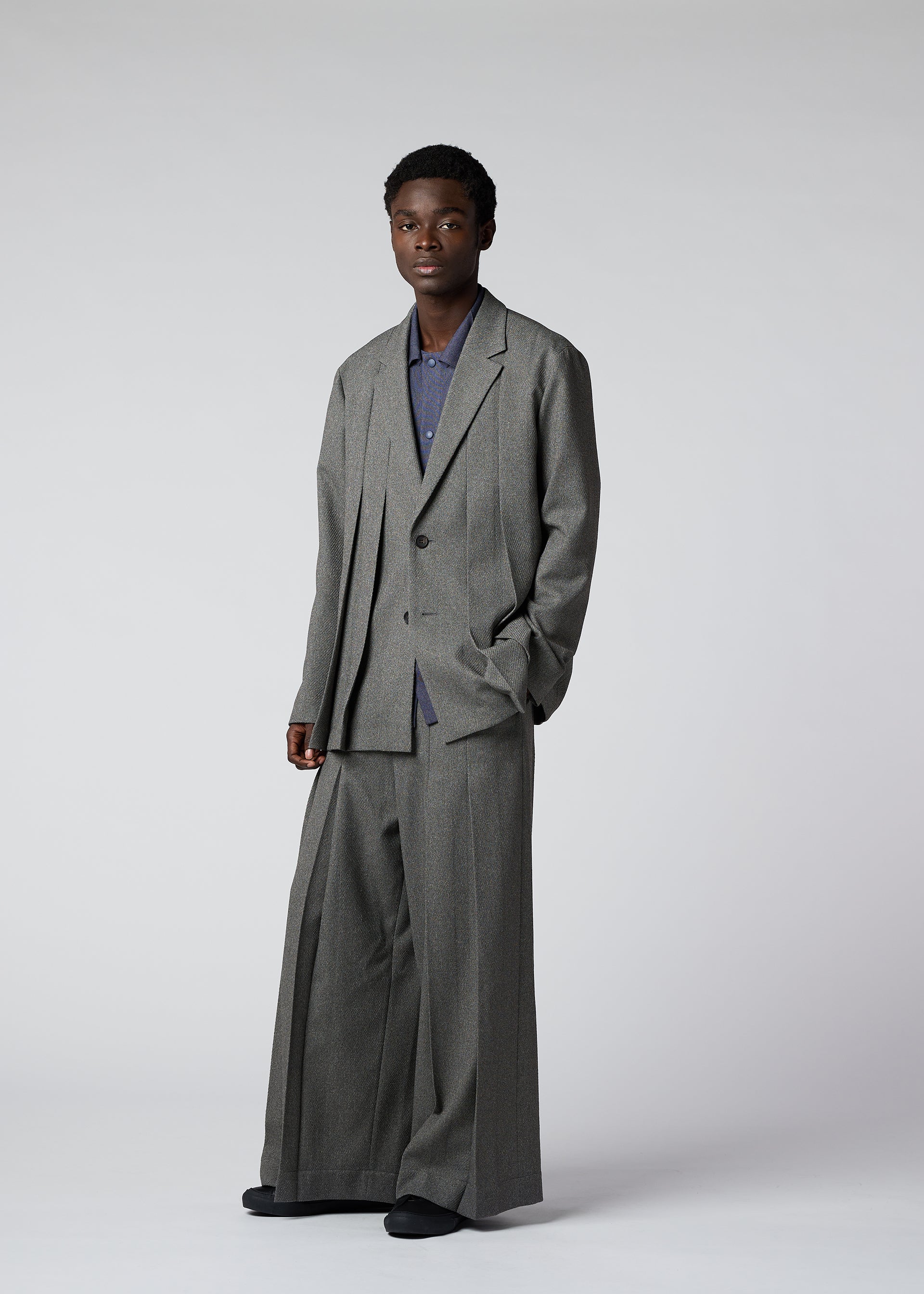 A model wears the IM Men WOOL LIKE TWEED trousers.