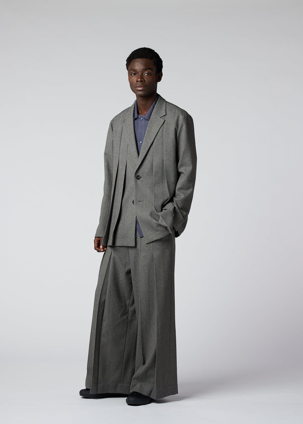 A model wears the IM Men WOOL LIKE TWEED trousers.