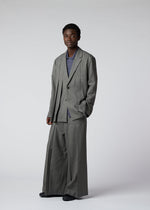A model wears the IM Men WOOL LIKE TWEED trousers.