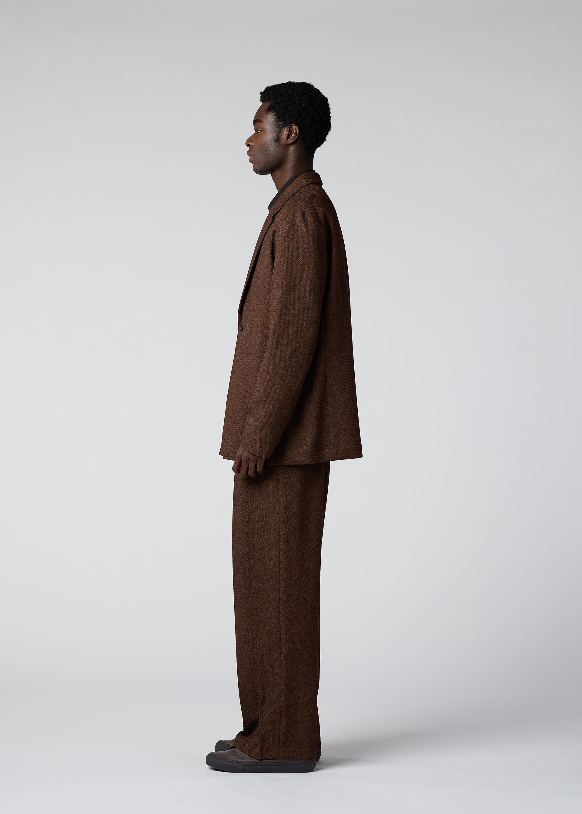 A model wears the IM Men WOOL LIKE TWEED trousers.