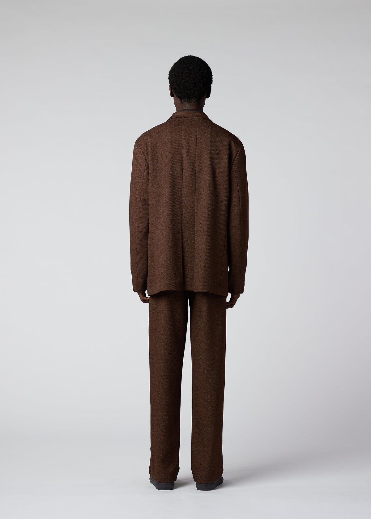 A model wears the IM Men WOOL LIKE TWEED trousers.