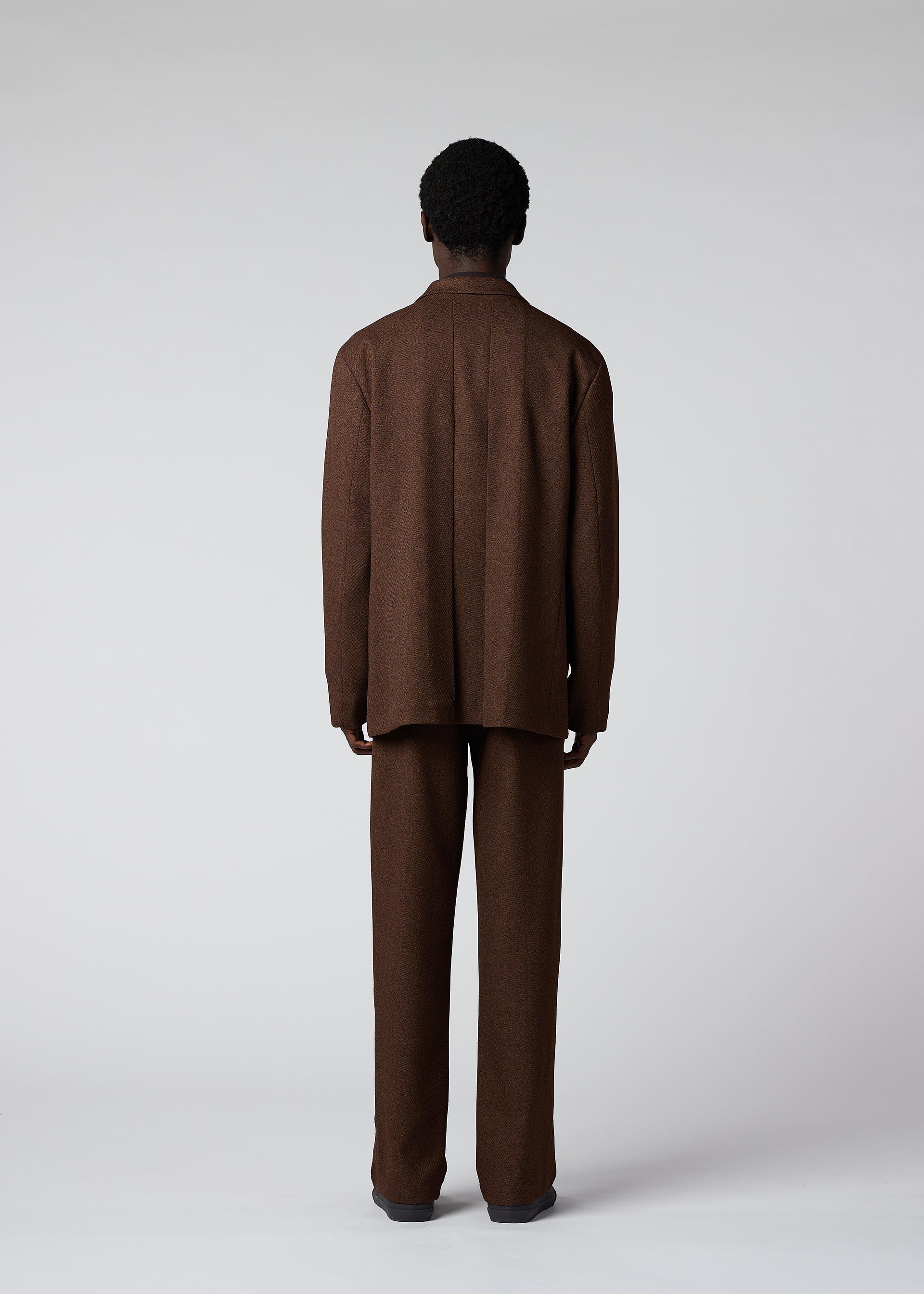 A model wears the IM Men WOOL LIKE TWEED trousers.