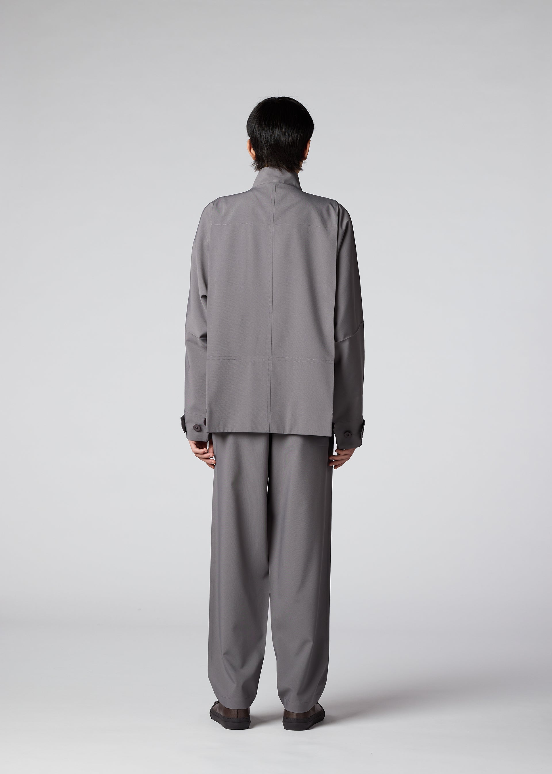 A model wears the IM MEN FLAT trousers.