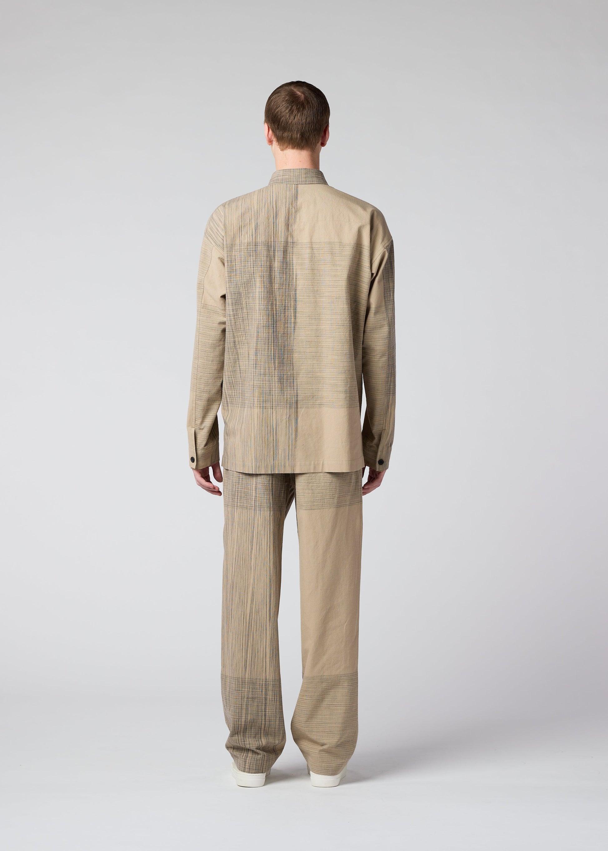 A model wears the IM MEN KASURI shirt.