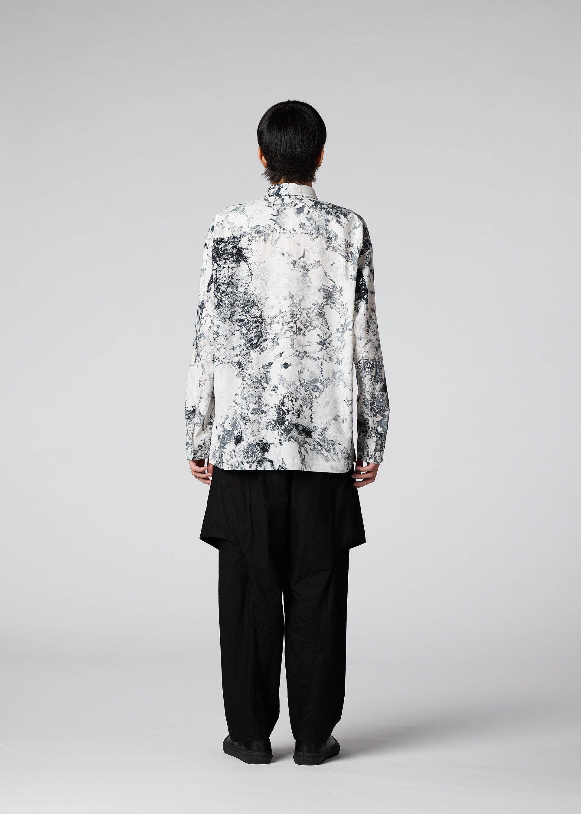 A model wears the IM Men ROKETSU shirt.