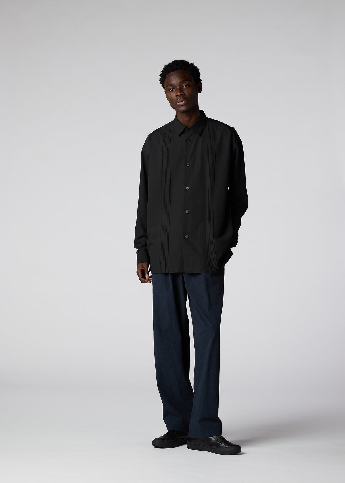 A model wears the IM Men PLEATS SHIRT shirt.