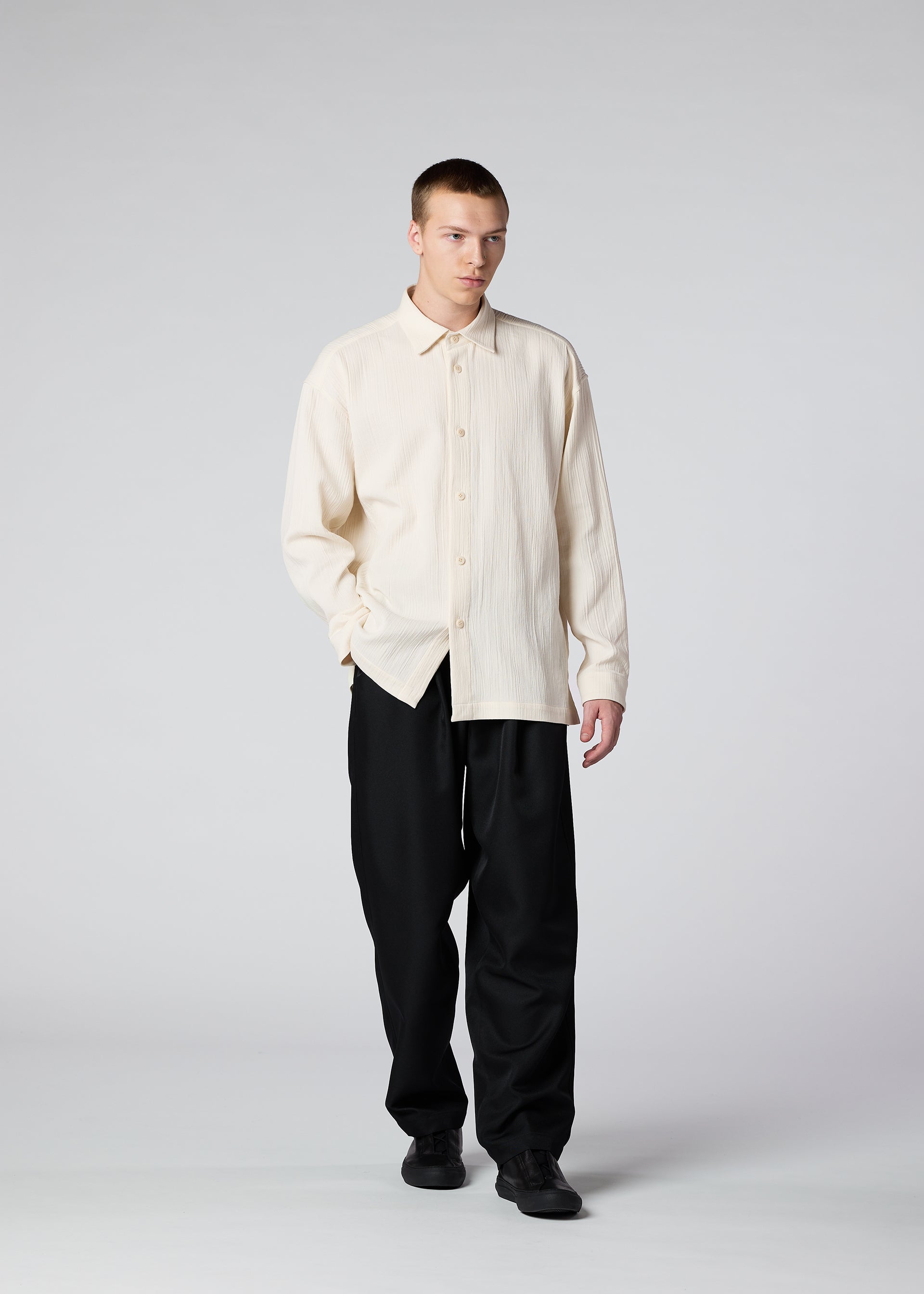 A model wears the IM Men DOUBLE WEAVE CREPE shirt.