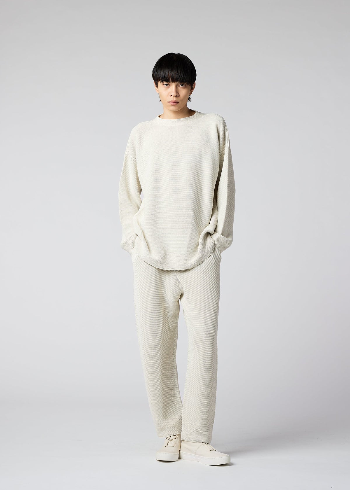 A model wears the IM Men SEAMLESS WASHI KNIT top.