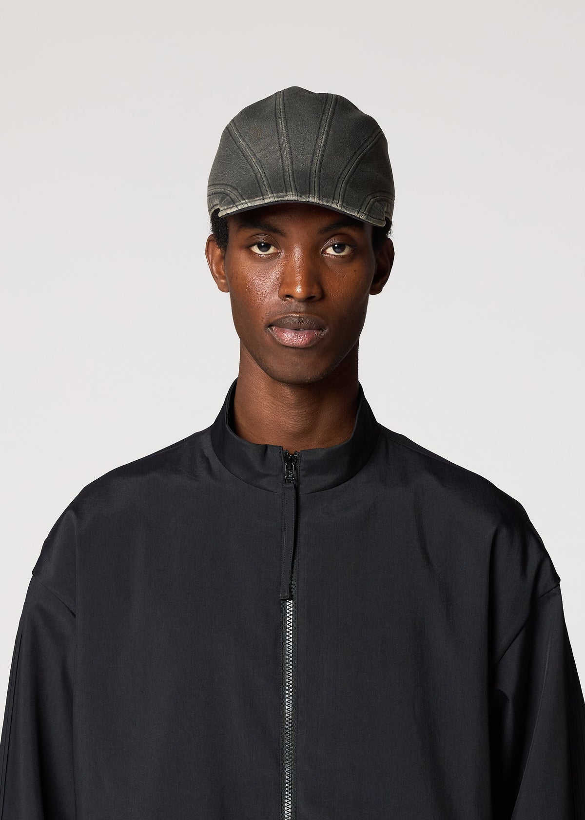 A model wears the IM Men CARVED CAP hat.