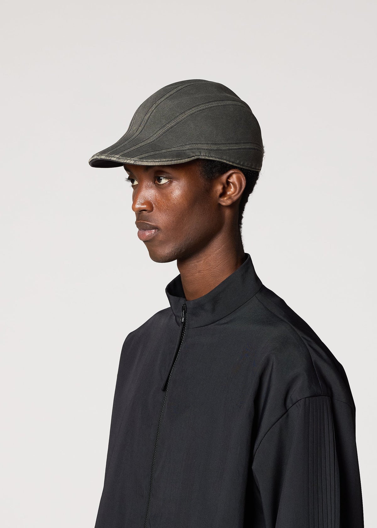A model wears the IM Men CARVED CAP hat.