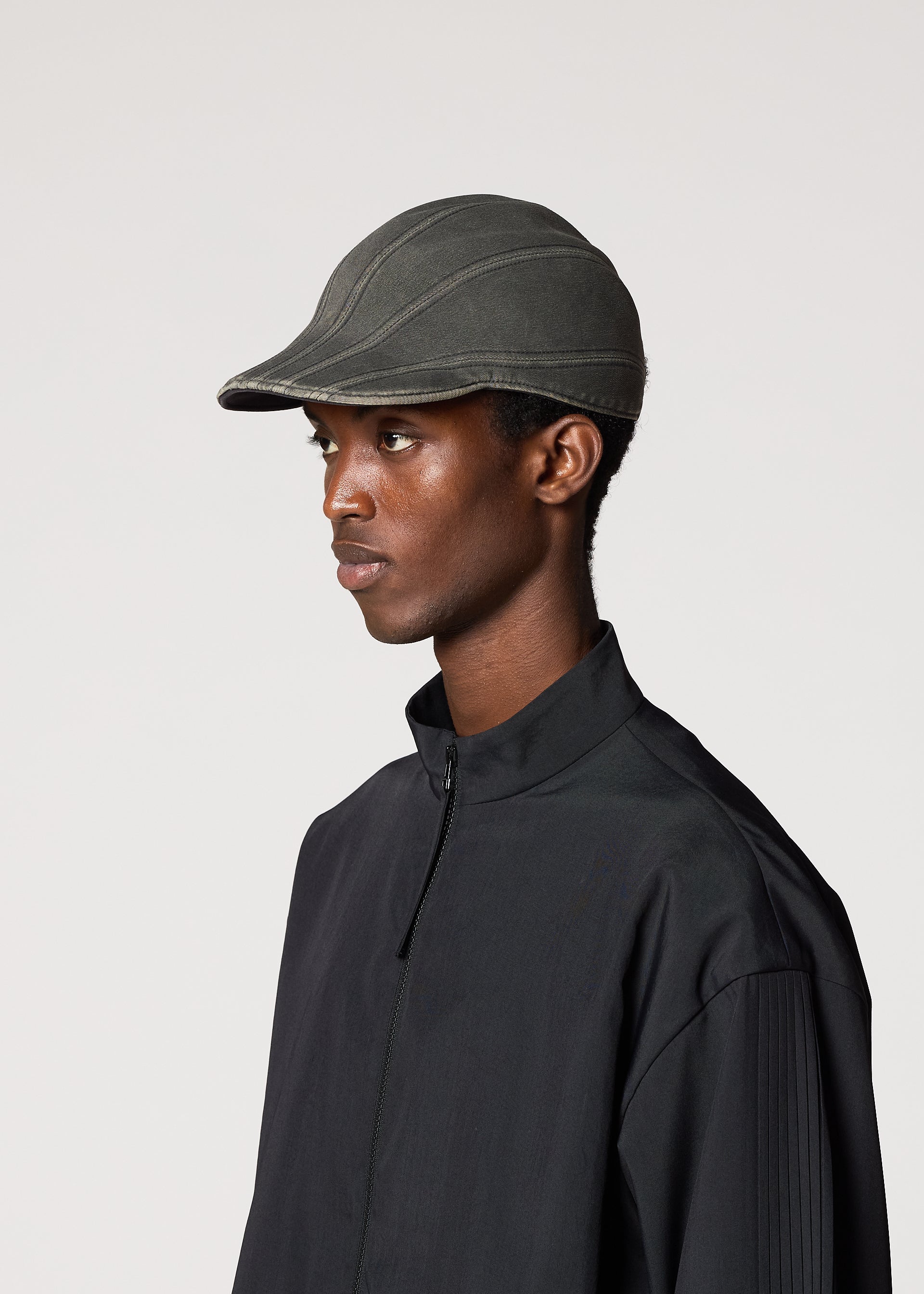 A model wears the IM Men CARVED CAP hat.