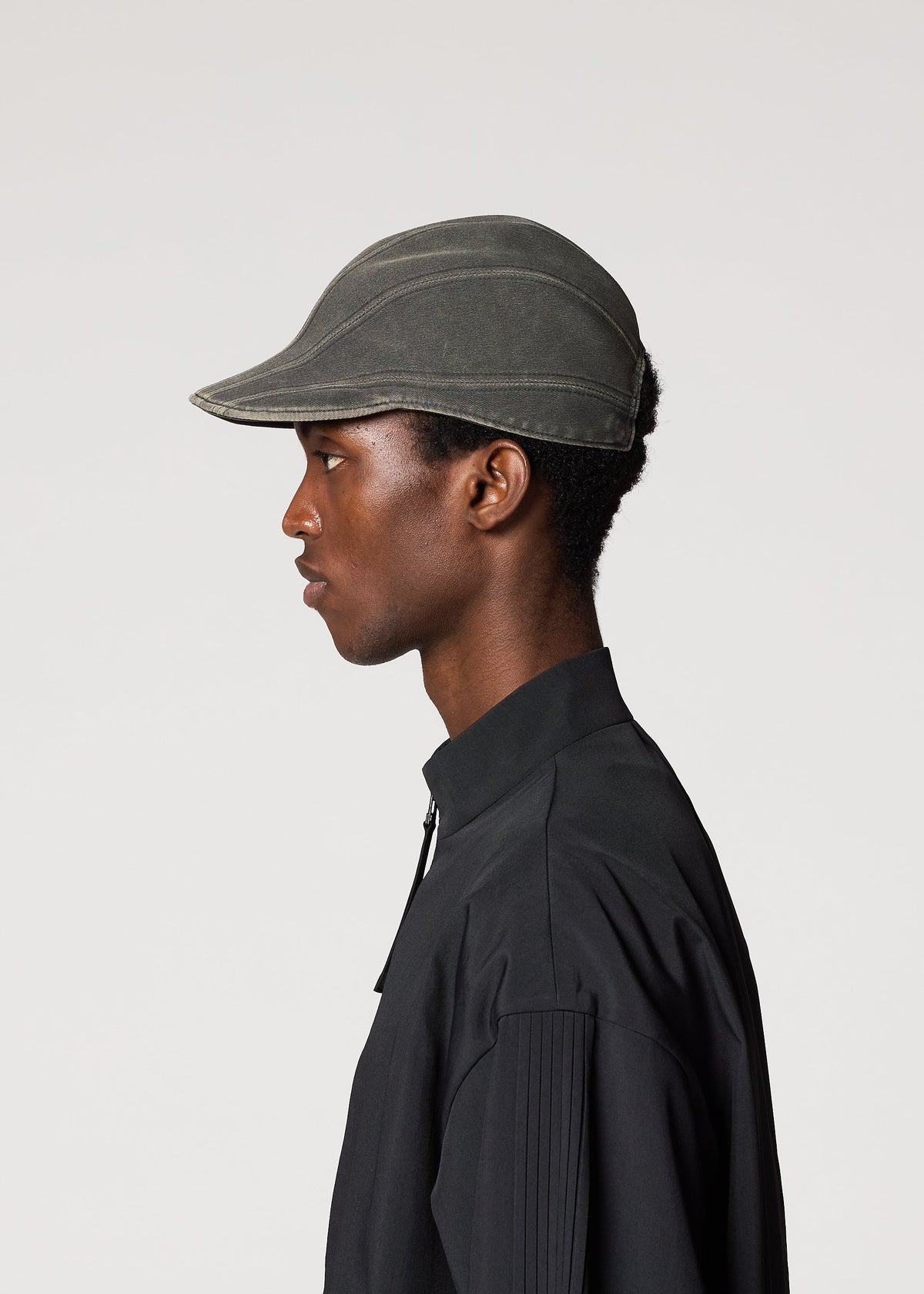 A model wears the IM Men CARVED CAP hat.