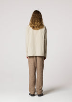 A model wears the IM MEN WHITE SHIRT prêt à porter.