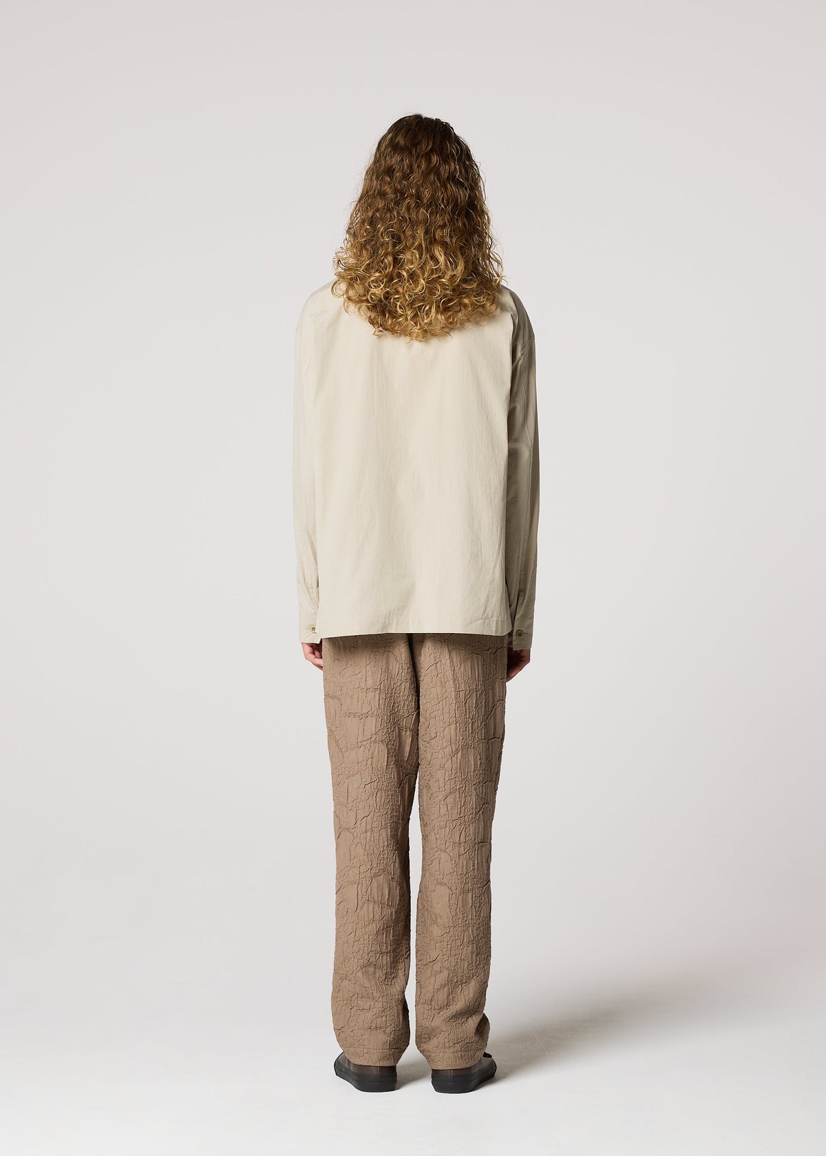 A model wears the IM MEN WHITE SHIRT prêt à porter.