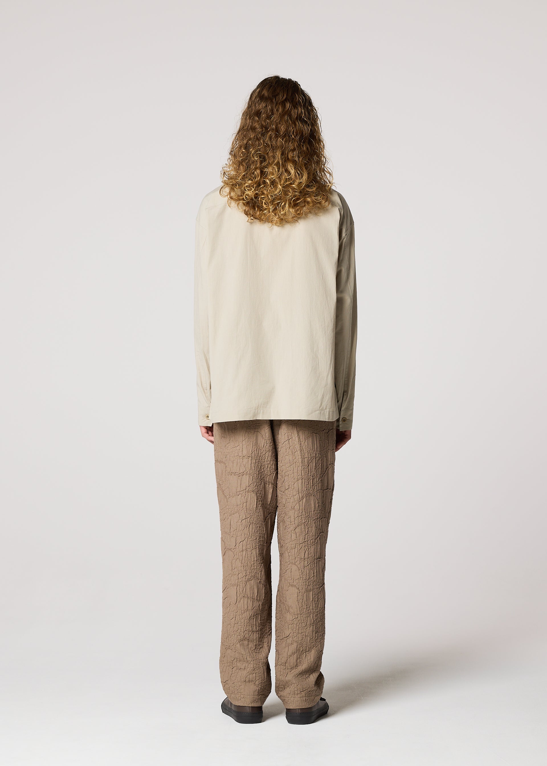 A model wears the IM MEN WHITE SHIRT prêt à porter.