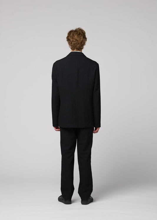 A model wears the IM MEN SHRINK WOOL jacket.