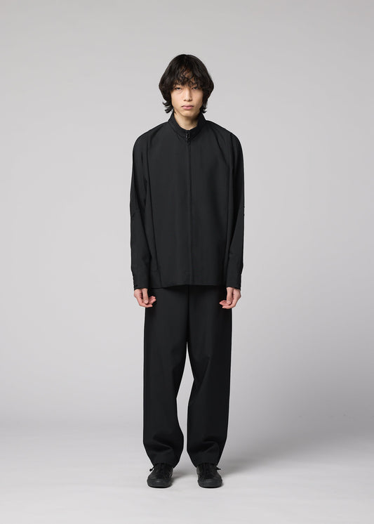 A model wears the IM MEN FLAT BLACK trousers.
