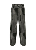 A product shot of the IM MEN KASURI pants in black.