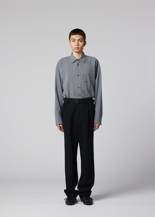 A model wears the IM MEN SHRINK WOOL trousers.
