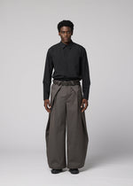 A model wears the IM MEN OVERLAP overlap-trousers-brown.