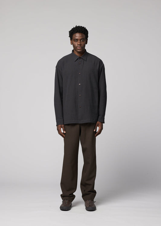 A model wears the IM MEN DOUBLE WEAVE CREPE shirt.