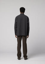 A model wears the IM MEN DOUBLE WEAVE CREPE shirt.