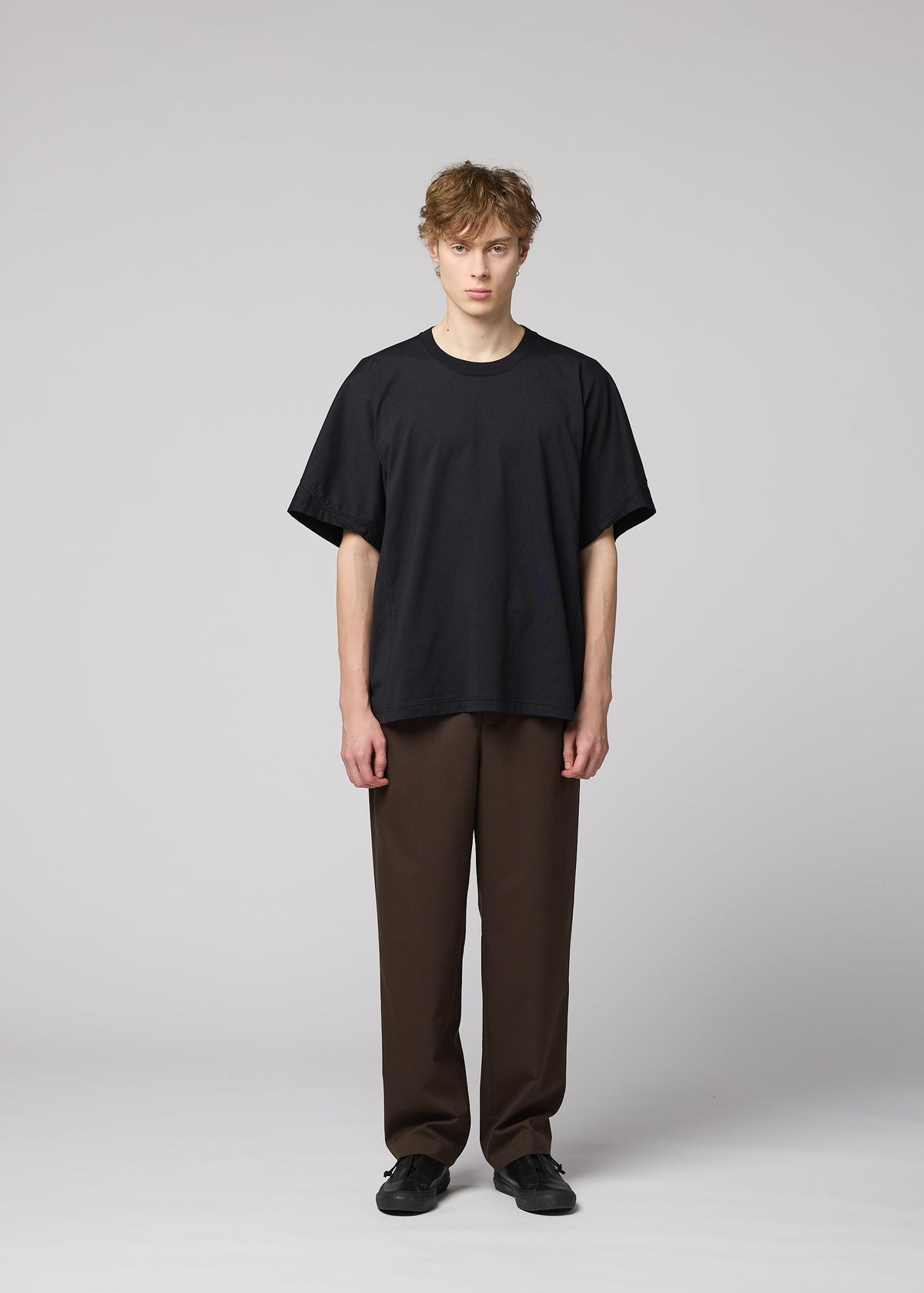 A model wears the IM MEN TURN turn-t-shirt-black-1.