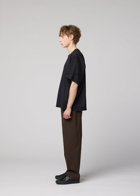 A model wears the IM MEN TURN turn-t-shirt-black-1.