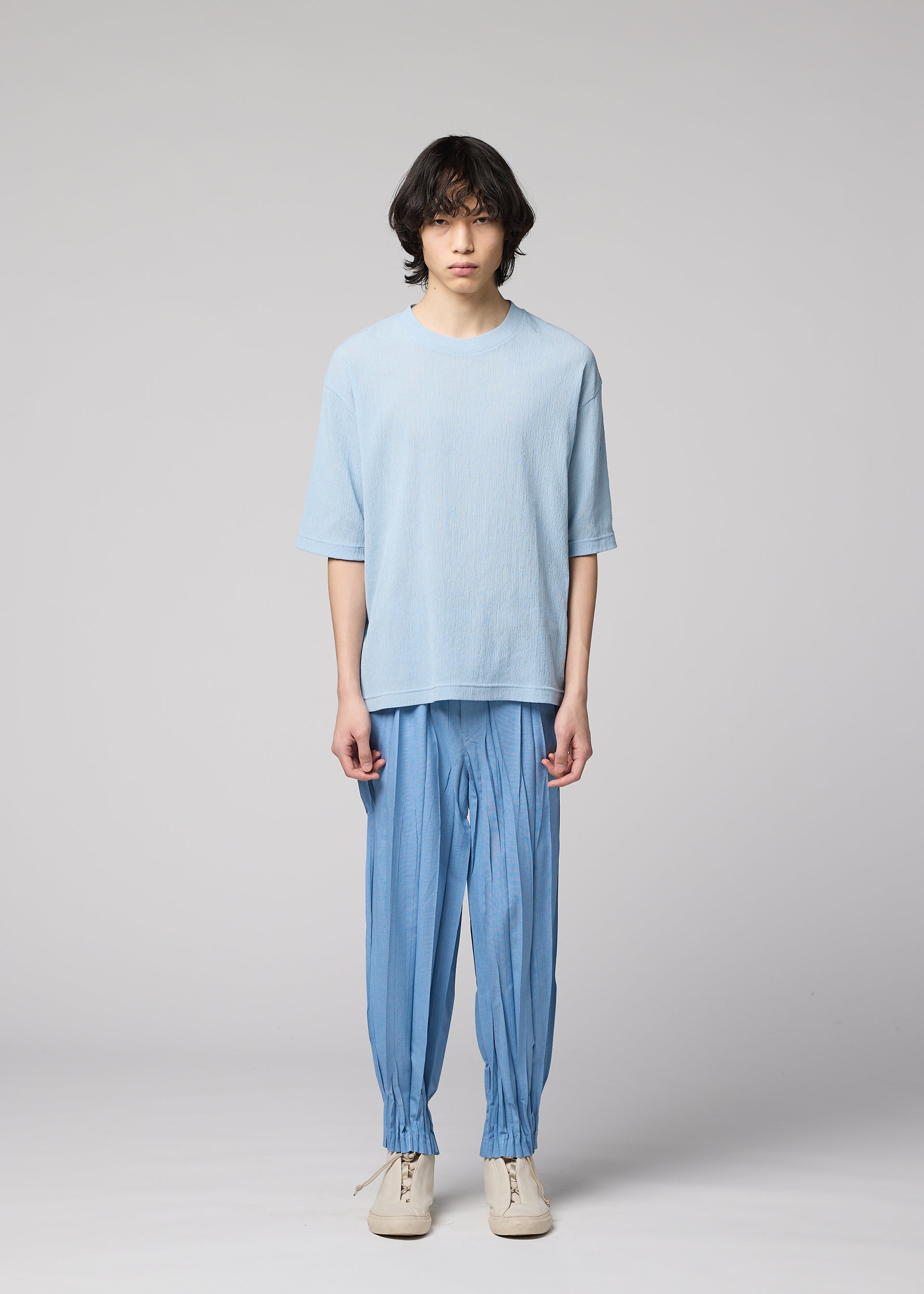 A model wears the IM MEN CREPE TUCK JERSEY crepe-tuck-jersey-t-shirt-light-beige.
