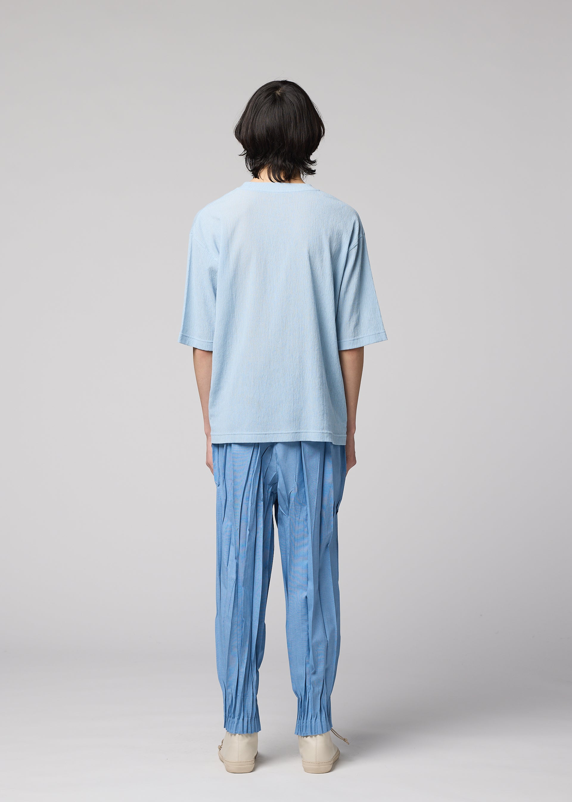 A model wears the IM MEN CREPE TUCK JERSEY crepe-tuck-jersey-t-shirt-black.