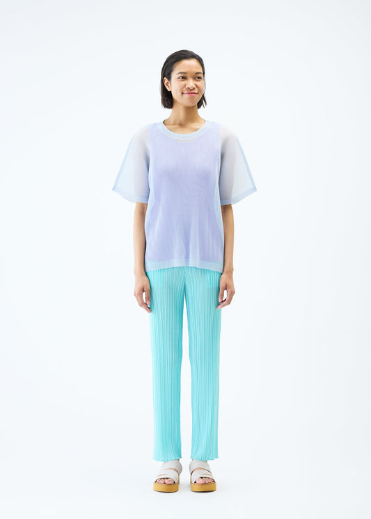 A model wears the PLEATS PLEASE ISSEY MIYAKE TATAMI APRIL top.