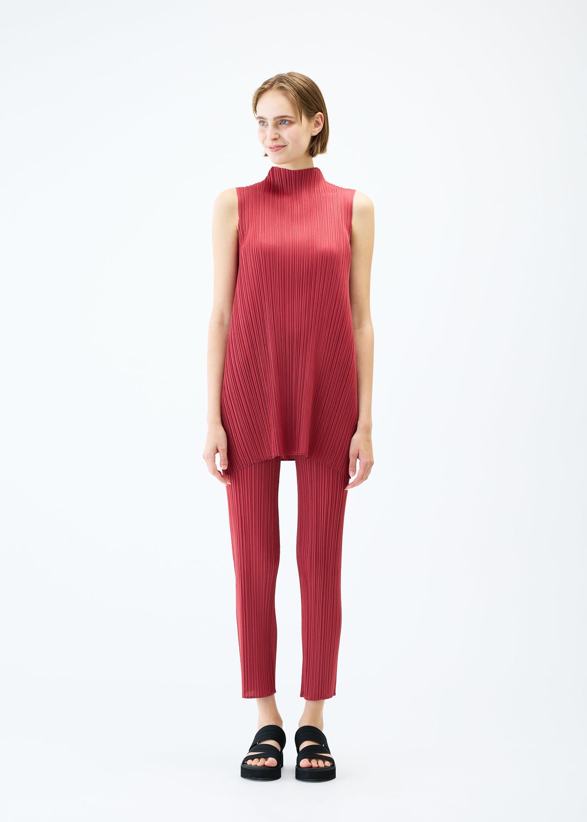 A model wears the PLEATS PLEASE ISSEY MIYAKE LAMP SHADE trousers.